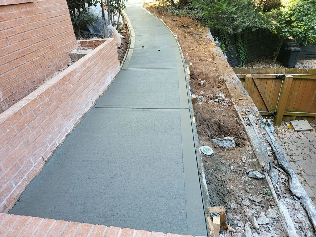 Freshly poured broom finish concrete walkway with forms still in place, walkways and sidewalks