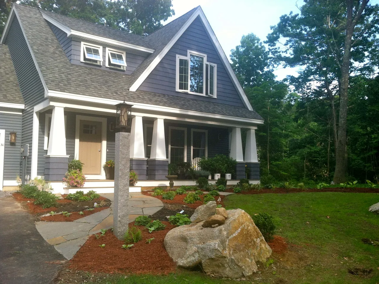 Flagstone walkway to a front porch between new planting beds, walkways and sidewalks